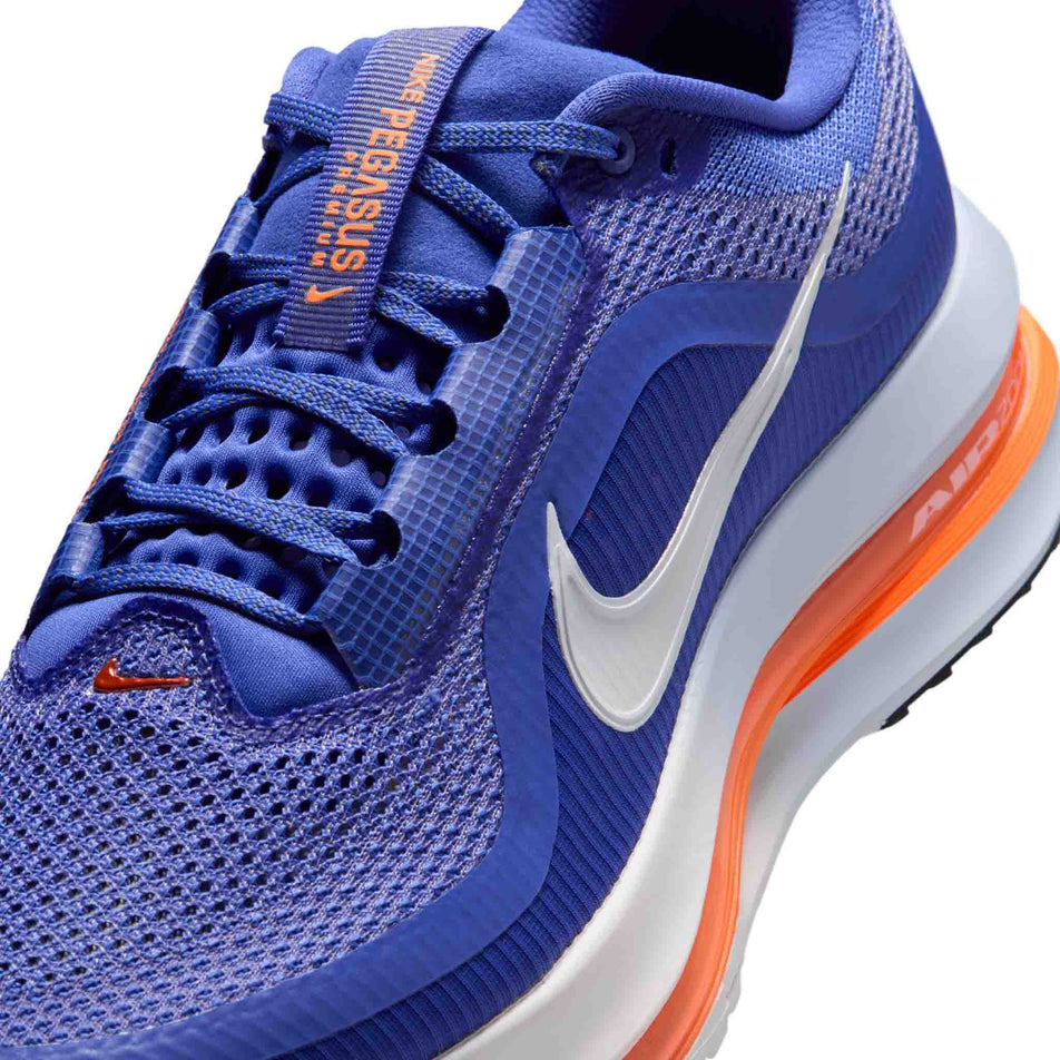 Close-up view of the upper of the left shoe from a pair of Nike Men's Pegasus Premium Road Running Shoes in the Lapis/White-Total Orange-Off Noir colourway.