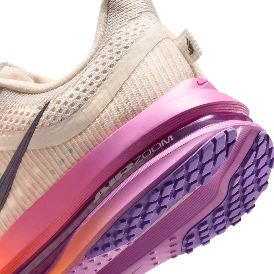 Close-up view of the rearfoot section of the left shoe from a pair of Nike Women's Pegasus Premium Road Running Shoes in the Chalk/Tattoo-Orange Pulse-Light Magenta colourway.