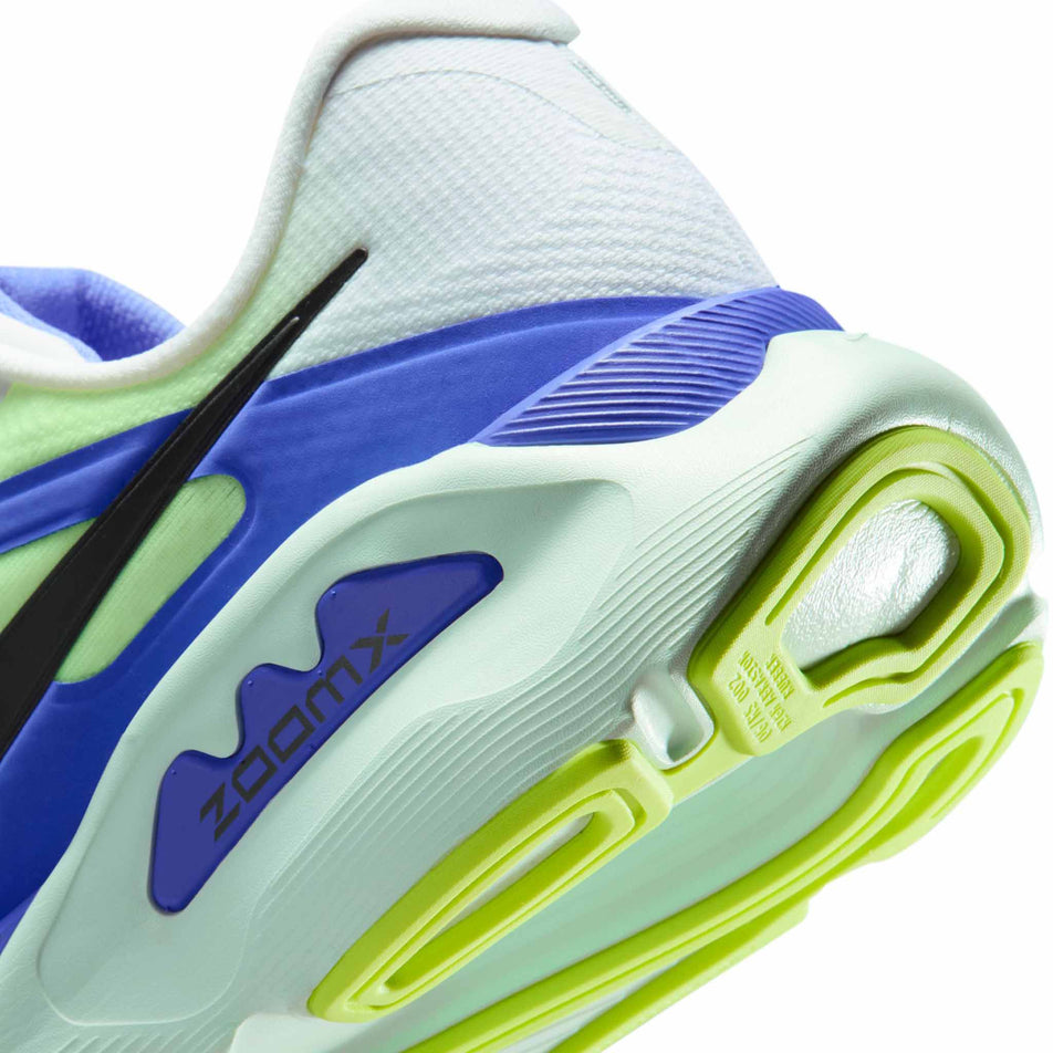 Close-up view of the rearfoot section of the left shoe from a pair of Nike Men's Structure Plus Road Running Shoes in the White/Black Spruce-Volt Ice-Barely Green colourway.