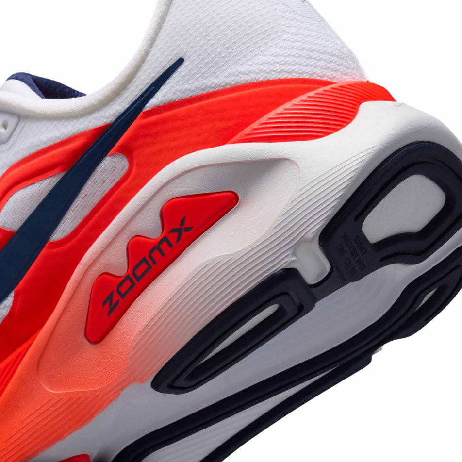 Close-up view of the rearfoot section of the left shoe from a pair of Nike Men's Structure Plus Road Running Shoes in the White/Midnight Navy-Bright Crimson colourway.