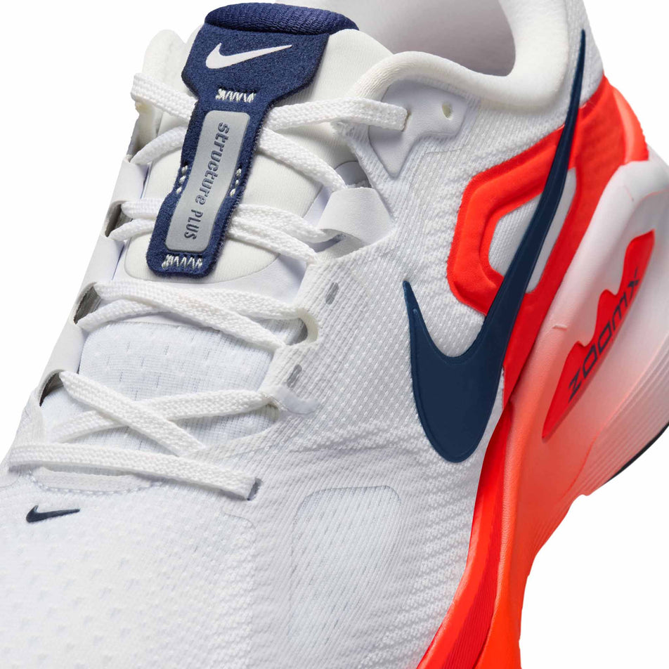 Close-up view of the upper of the left shoe from a pair of Nike Men's Structure Plus Road Running Shoes in the White/Midnight Navy-Bright Crimson colourway.
