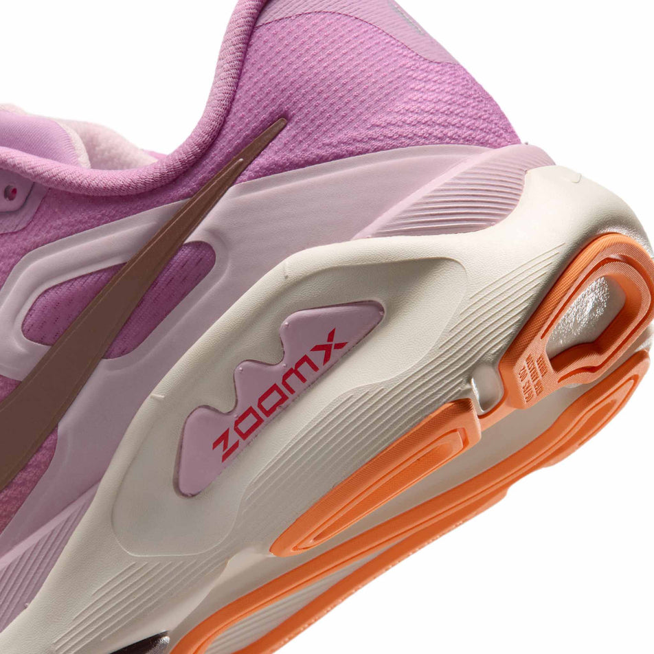 Close-up view of the rearfoot section of the left shoe from a pair of Nike Women's Structure Plus Road Running Shoes in the Light Magenta/Tattoo-Orange Pulse-Pink Foam colourway.