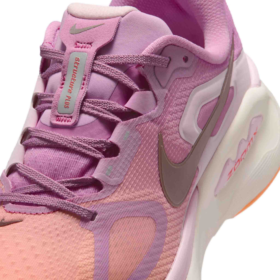 Close-up view of the upper of the left shoe from a pair of Nike Women's Structure Plus Road Running Shoes in the Light Magenta/Tattoo-Orange Pulse-Pink Foam colourway.