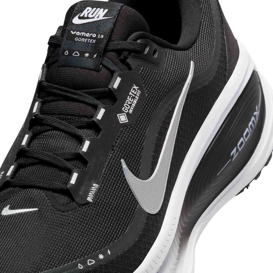 Close-up view of the upper of the left shoe from a pair of Nike Men's Vomero 18 GORE-TEX Road Running Shoes in the Black/Metallic Silver-Anthracite-White colourway. (8754898501794)