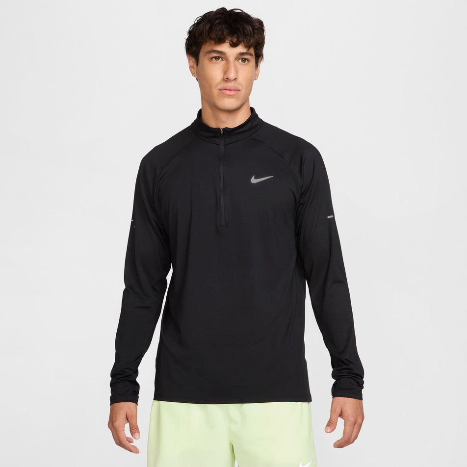 Front view of a model wearing the Nike Men's Stride Dri-FIT 1/4-Zip Running Top in the Black/Reflective Silver  colourway. (8778198876322)