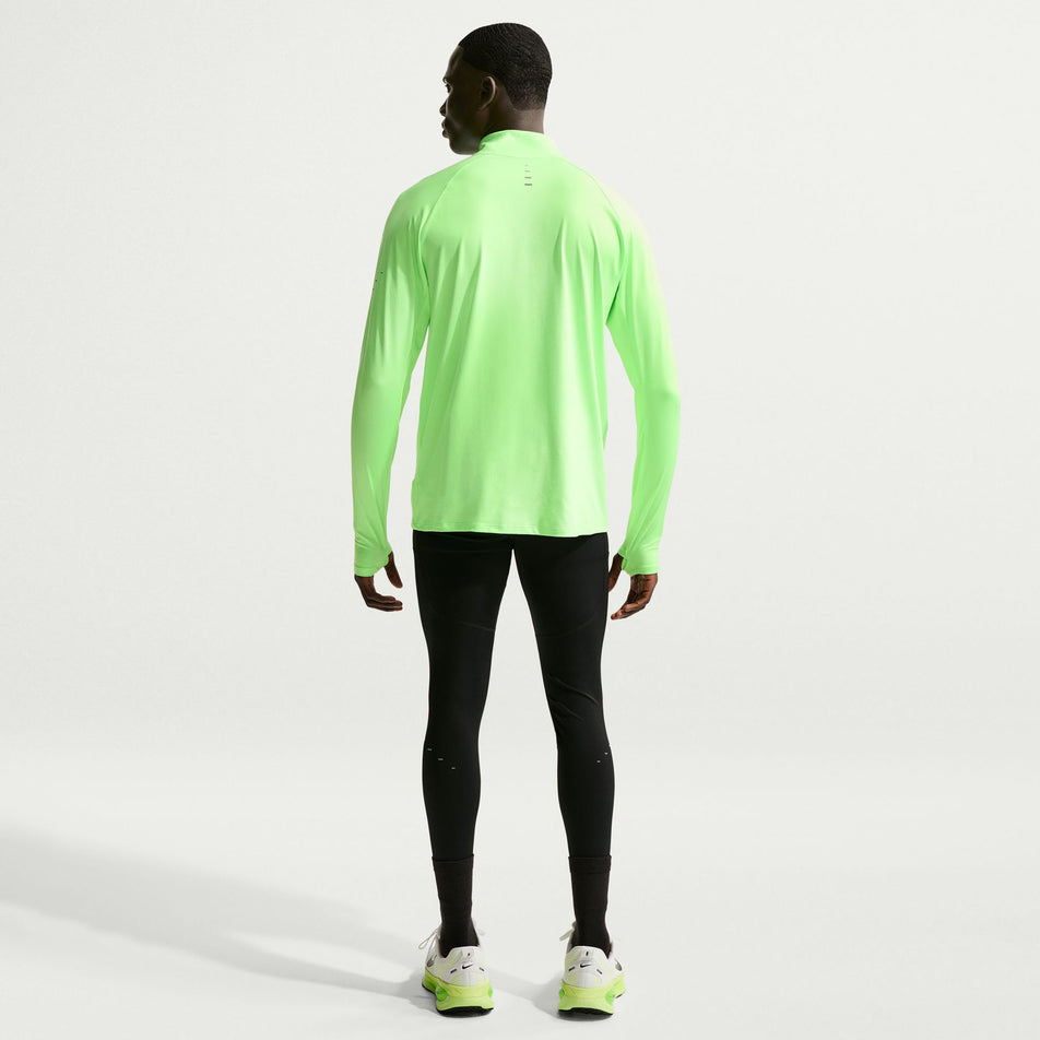 Back view of a model wearing the Nike Men's Stride Dri-FIT 1/4-Zip Running Top in the Lime Blast/Reflective Silver colourway.