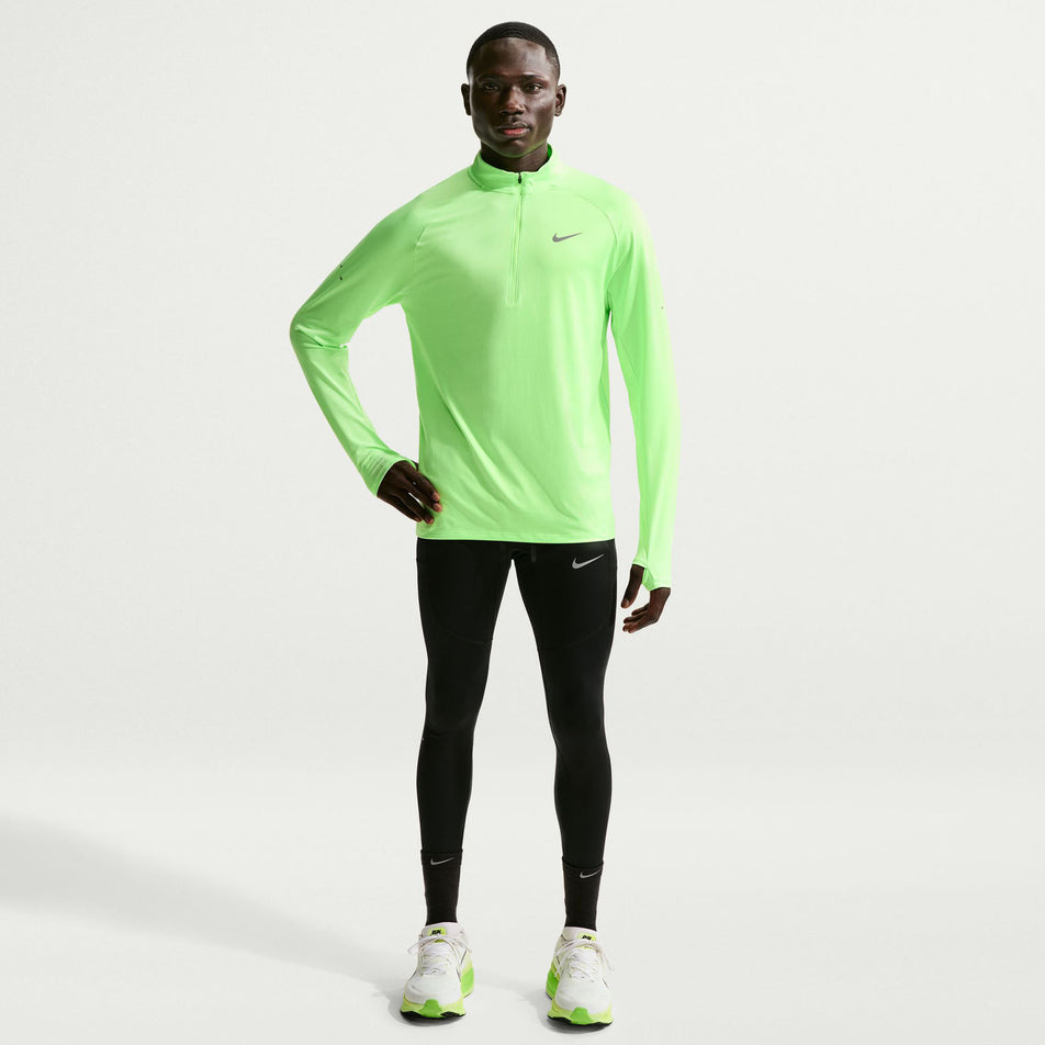 Front view of a model wearing the Nike Men's Stride Dri-FIT 1/4-Zip Running Top in the Lime Blast/Reflective Silver colourway.