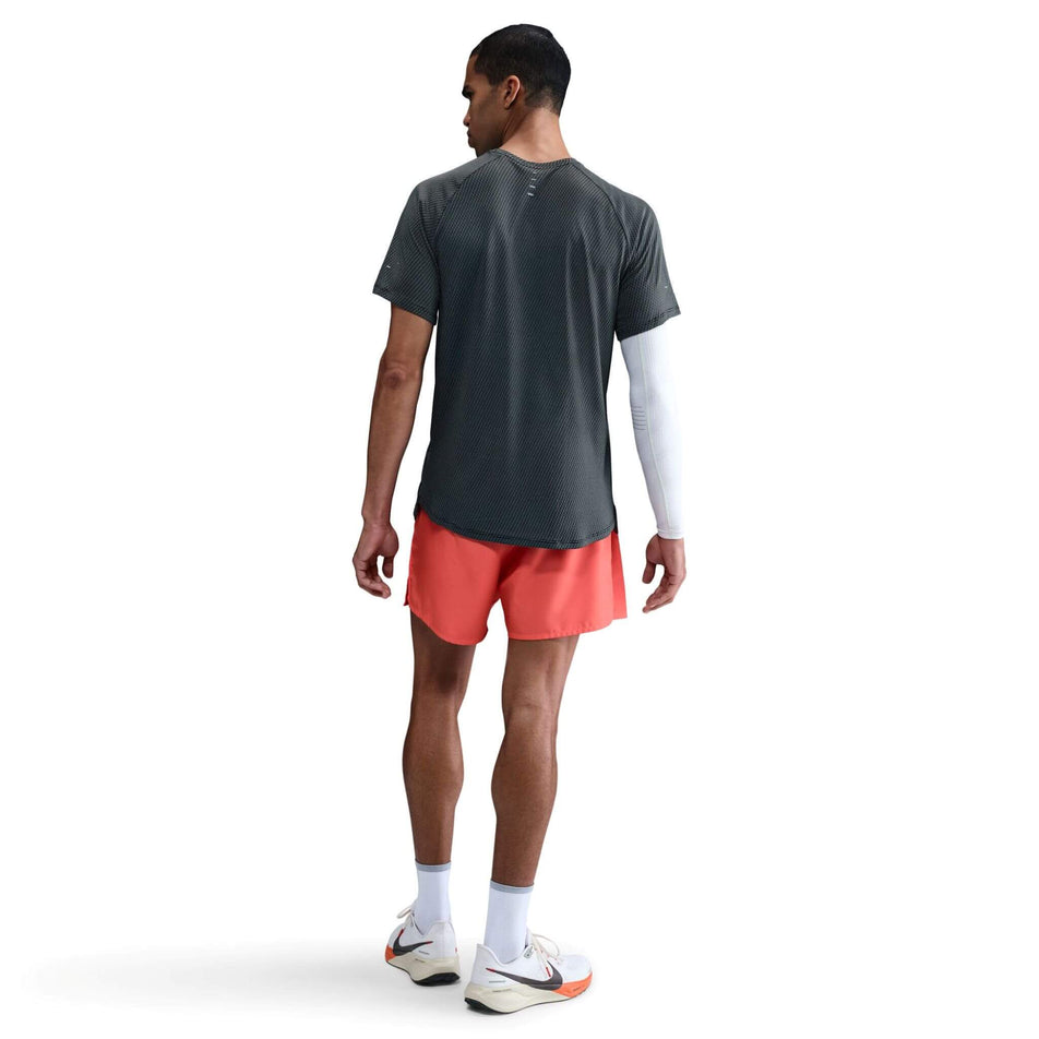 Back view of a model wearing the Nike Men's Dri-FIT Stride Jacquard Short-Sleeve Running Top in the Black/Reflective Silver colourway. (8716705202338)