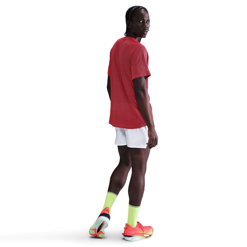 Back view of a model wearing the Nike Men's Dri-FIT Stride Jacquard Short-Sleeve Running Top in the Bright Crimson/Reflective Silver colourway. (8716724895906)