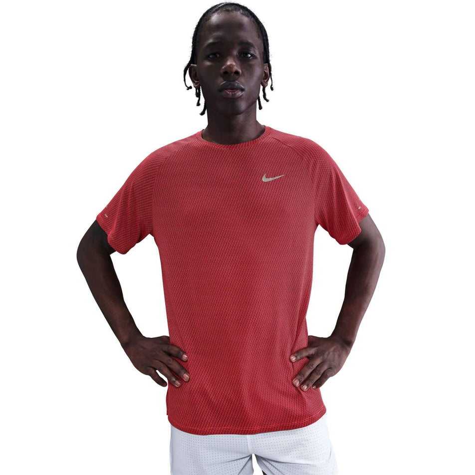 Front view of a model wearing the Nike Men's Dri-FIT Stride Jacquard Short-Sleeve Running Top in the Bright Crimson/Reflective Silver colourway. (8716724895906)