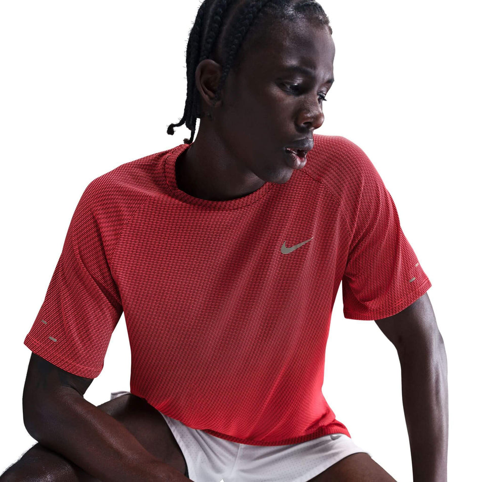 Front view of a model wearing the Nike Men's Dri-FIT Stride Jacquard Short-Sleeve Running Top in the Bright Crimson/Reflective Silver colourway. (8716724895906)