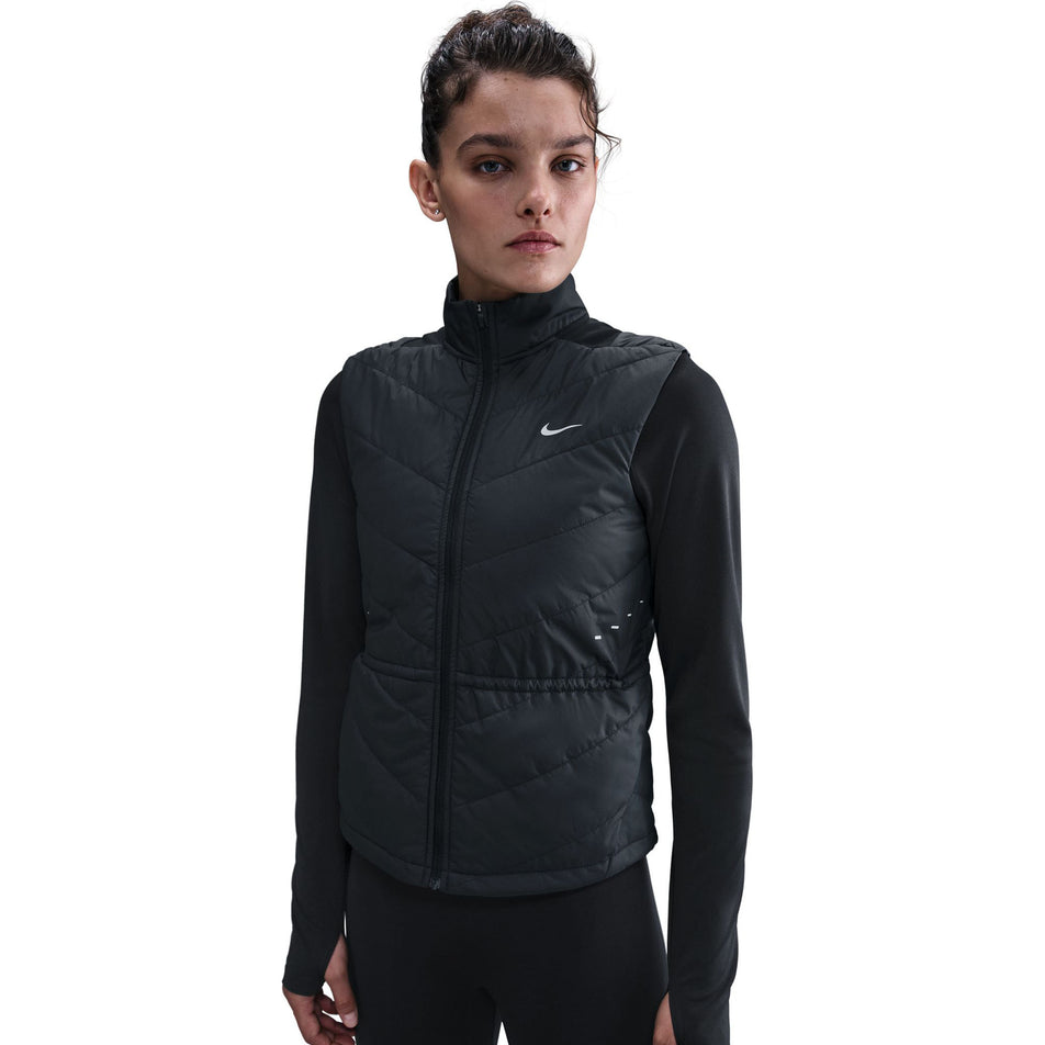 Front view of a model wearing the Nike Women's Swift Therma-FIT Running Vest in the Black/Reflective Silver colourway.