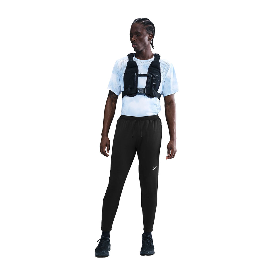Front view of a model wearing the Nike Men's Dri-FIT Stride Knit Running Pants in the Black/Reflective Silver colourway. (8733229744290)