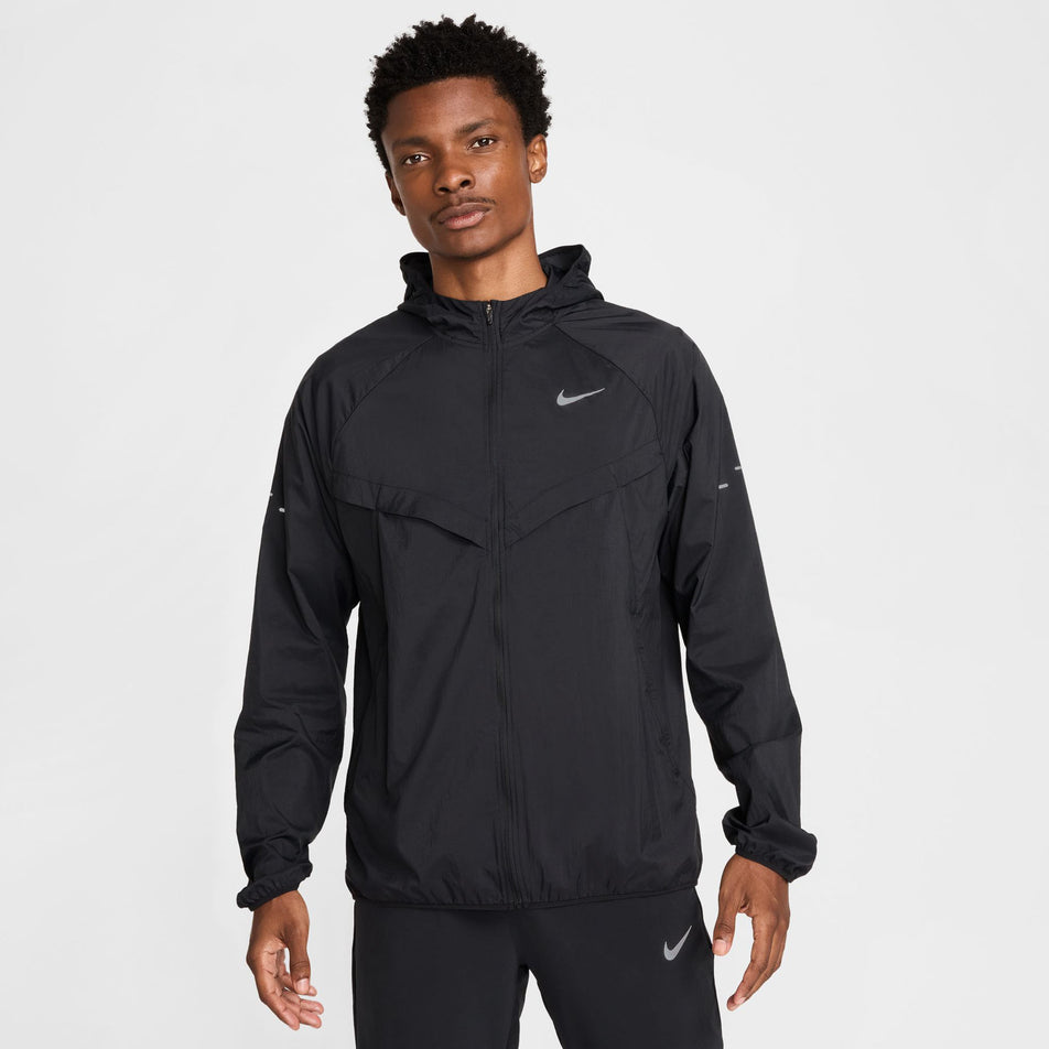 Front view of a model wearing the Nike Men's Stride Repel UV Running Jacket in the Black/Black/Reflective Silver colourway.