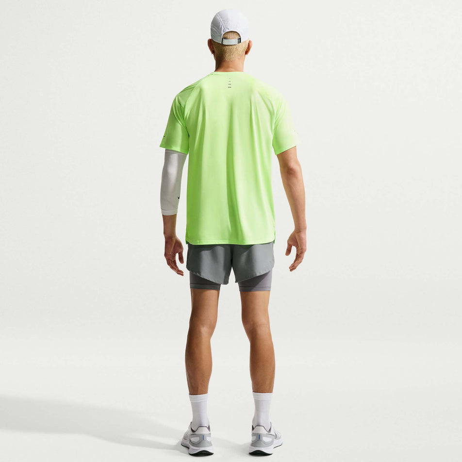Back view of a model wearing the Nike Men's Stride Dri-FIT ADV Short-Sleeve Running Top in the Lime Blast/Reflective Silver colourway.