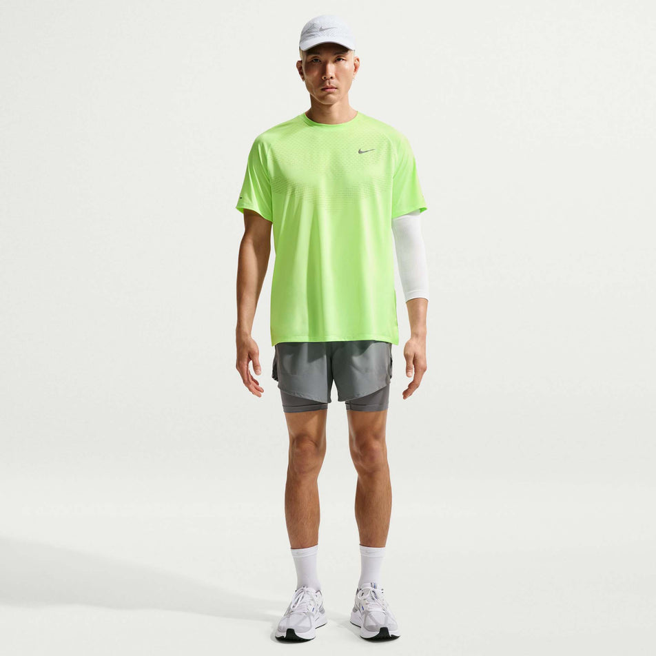 Front view of a model wearing the Nike Men's Stride Dri-FIT ADV Short-Sleeve Running Top in the Lime Blast/Reflective Silver colourway.