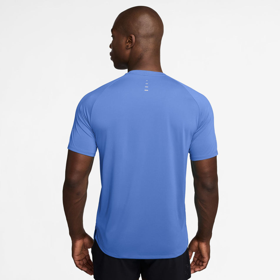 Back view of a model wearing the Nike Men's Stride Dri-FIT ADV Short-Sleeve Running Top in the Royal Pulse/Reflective Silver colourway.