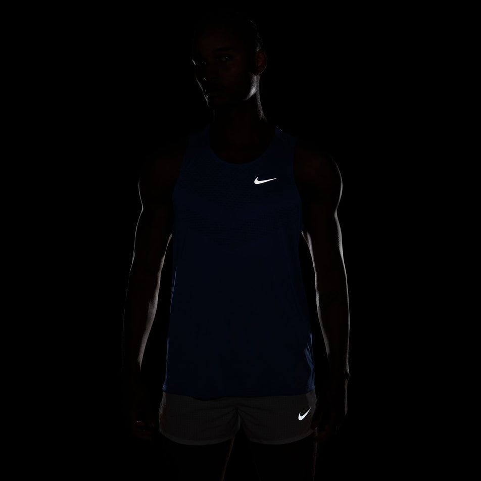 The reflective swoosh on the front of the Nike Men's Stride Dri-FIT ADV Running Tank Top in the Royal Pulse/Reflective Silver colourway.