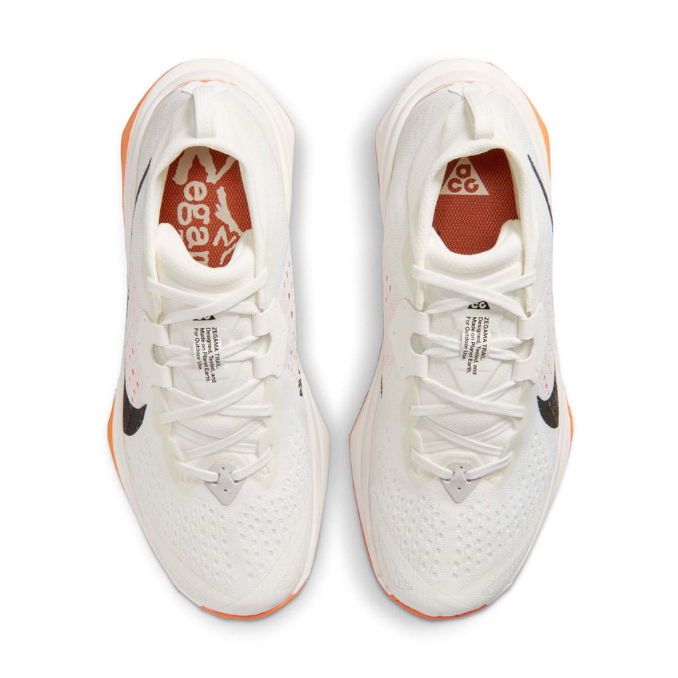 The uppers of a pair of Nike Women's ACG Zegama Trail Running Shoes -in the Summit White/Black-Phantom-Safety Orange colourway.