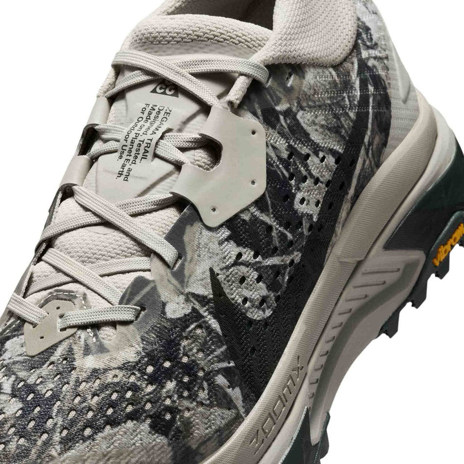 Close-up view of the upper of the left shoe from a pair of Nike Women's ACG Zegama Trail Running Shoes in the Spruce Fog/Black Spruce-Sea Glass-Black colourway.