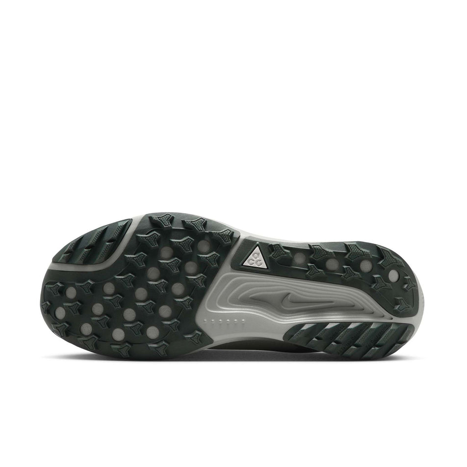 The outsole of the left shoe from a pair of Nike Men's ACG Pegasus Trail Running Shoes in the Spruce Fog/Black Spruce-Sea Glass colourway.