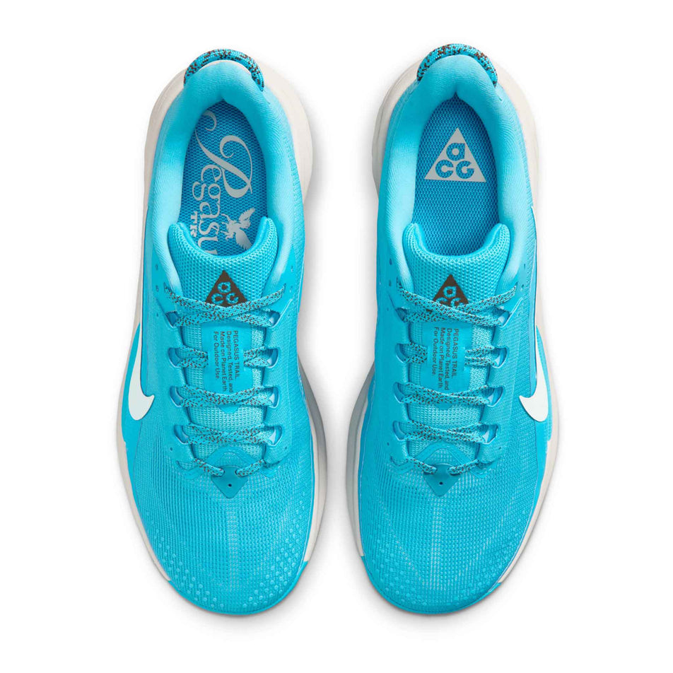 The uppers of a pair of Nike Men's ACG Pegasus Trail Running Shoes in the Baltic Blue/Summit White-Light Orewood Brown colourway.
