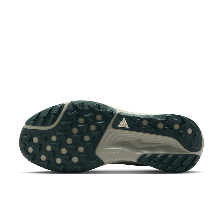 The outsole of the left shoe from a pair of Nike Women's ACG Pegasus Trail Running Shoes in the Spruce Fog/Black Spruce-Sea Glass colourway.