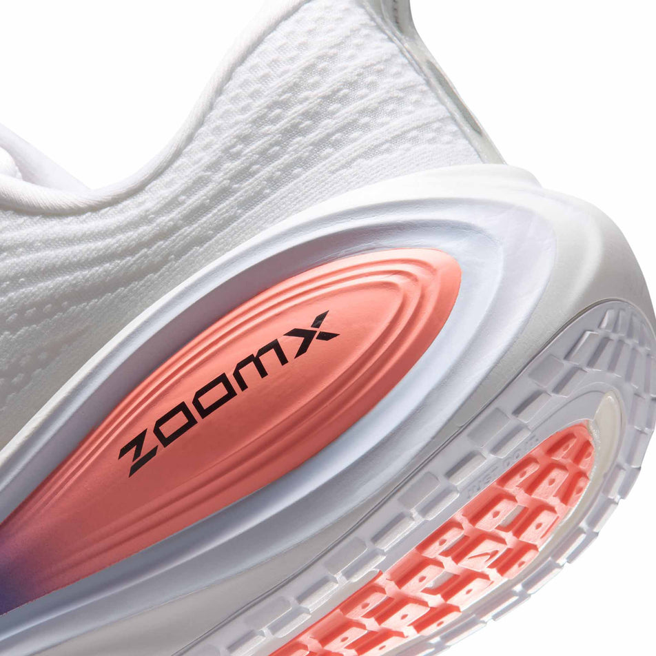 Close-up view of the rearfoot section of the left shoe from a pair of Nike Men's Vomero Plus Road Running Shoes in the White/Black-Atomic Pink-Racer Blue colourway.