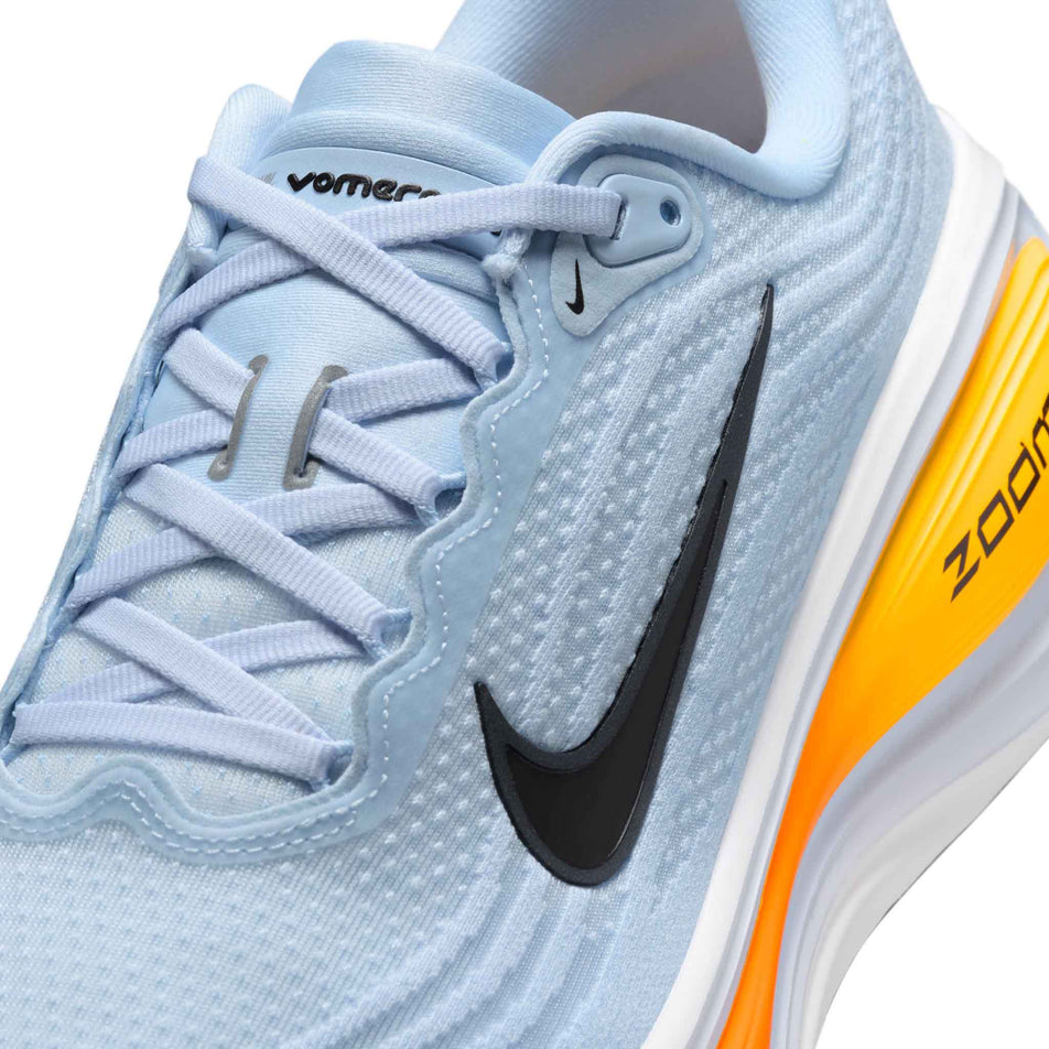 Close-up view of the upper of the left shoe from a pair of Nike Men's Vomero Plus Road Running Shoes in the Hydrogen Blue/Black-White-Total Orange colourway.