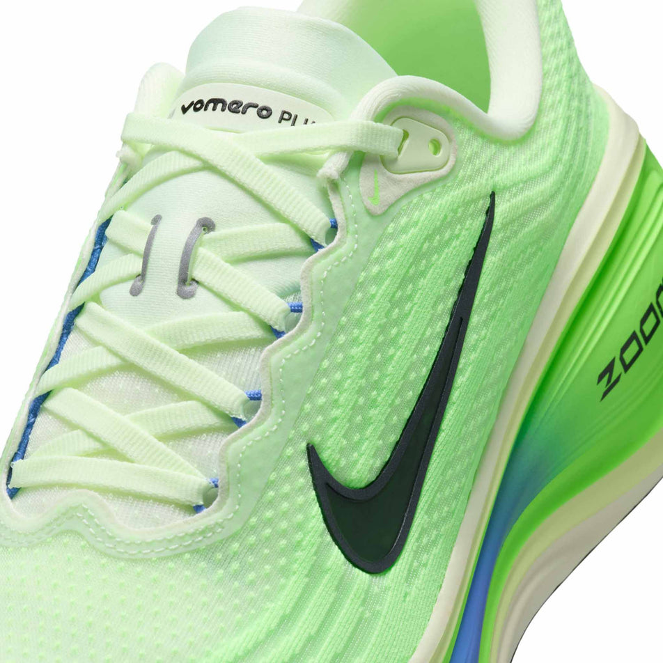Close-up view of the upper of the left shoe from a pair of Nike Men's Vomero Plus Road Running Shoes in the Volt Tint/Black Spruce-Lime Blast colourway.