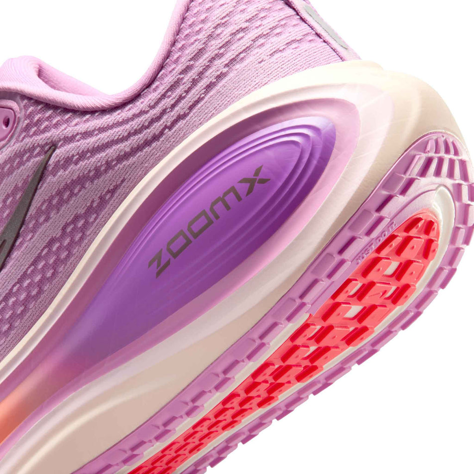 Close-up view of the rearfoot section of the left shoe from a pair of Nike Women's Vomero Plus Road Running Shoes in the Light Magenta/Black-Pink Foam-Bright Violet colourway.