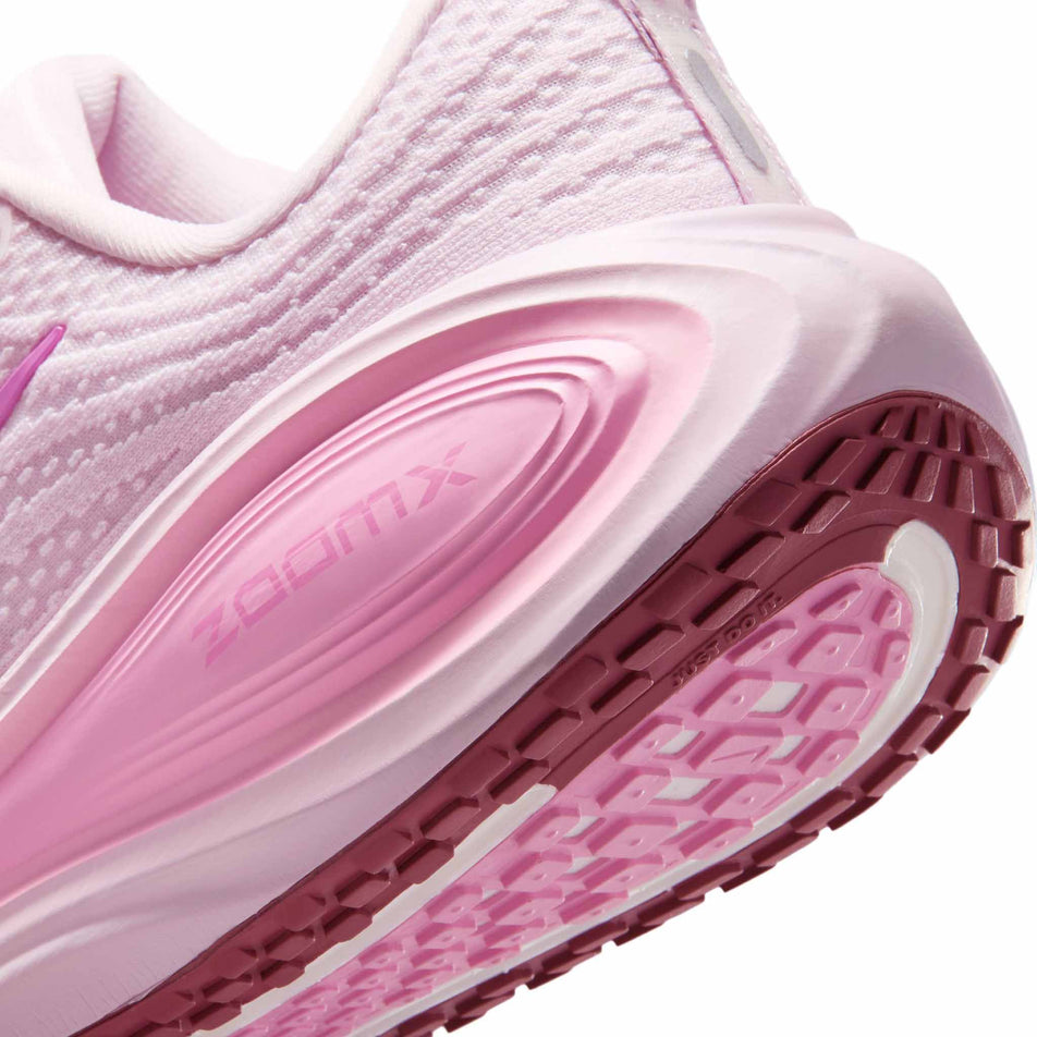 Close-up view of the rearfoot section of the left shoe from a pair of Nike Women's Vomero Plus Road Running Shoes in the Bleached Lilac/Light Magenta-Pink Rise colourway.
