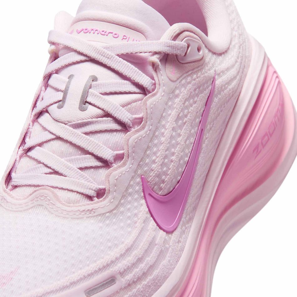 Close-up view of the upper of the left shoe from a pair of Nike Women's Vomero Plus Road Running Shoes in the Bleached Lilac/Light Magenta-Pink Rise colourway.