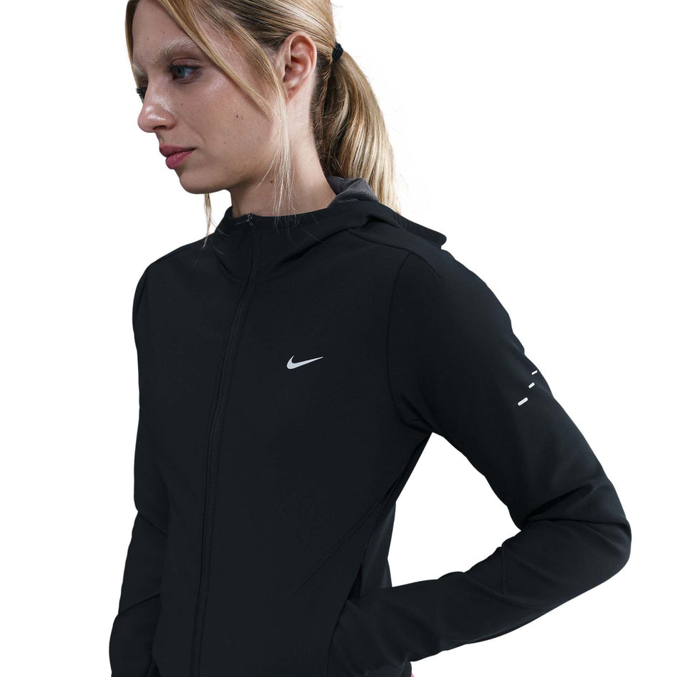 Front view of a model wearing the Nike Women's Swift Therma-FIT Running Jacket in the Black/Reflective Silver colourway.