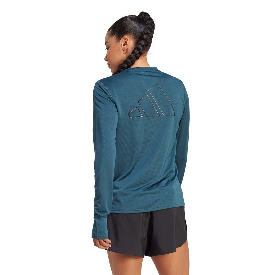 Back view of a model wearing an adidas Women's Run Icons Running Long-Sleeve Top in the Arctic Night colourway (8005336432802)