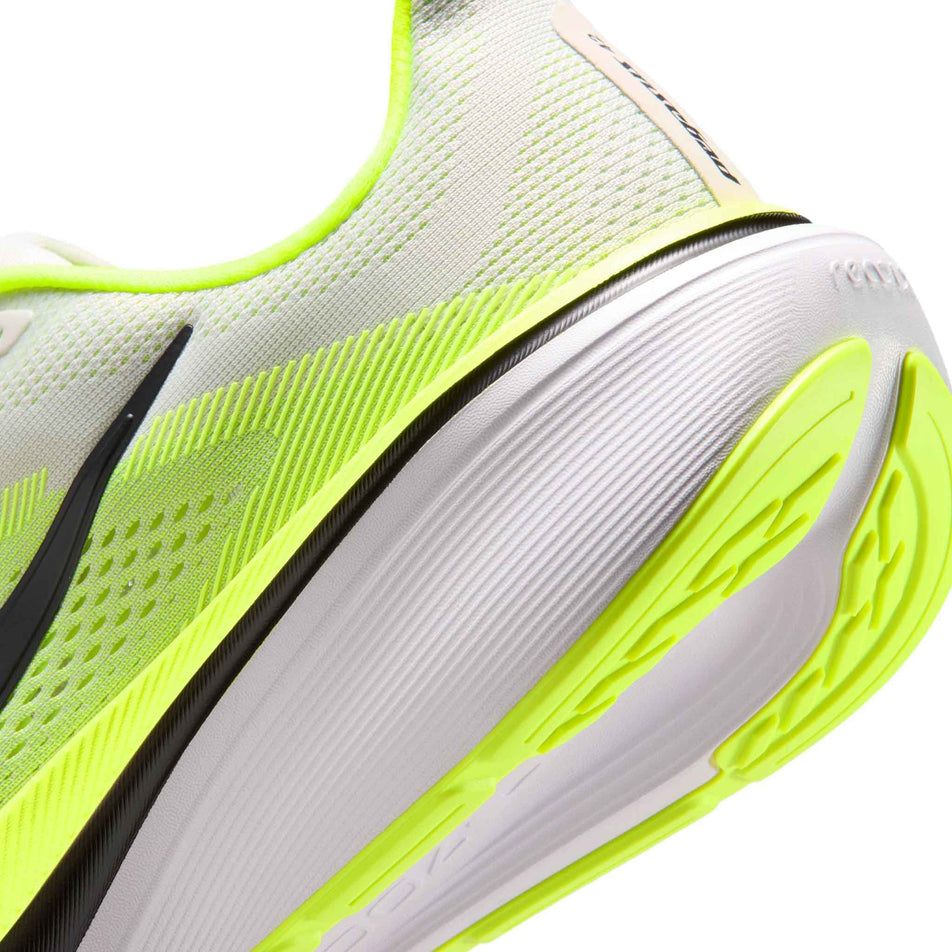 Close-up view of the rearfoot section of the left shoe from a pair of Nike Men's Pegasus 42 Road Running Shoes in the Photon Dust/Black-Volt-White colourway.