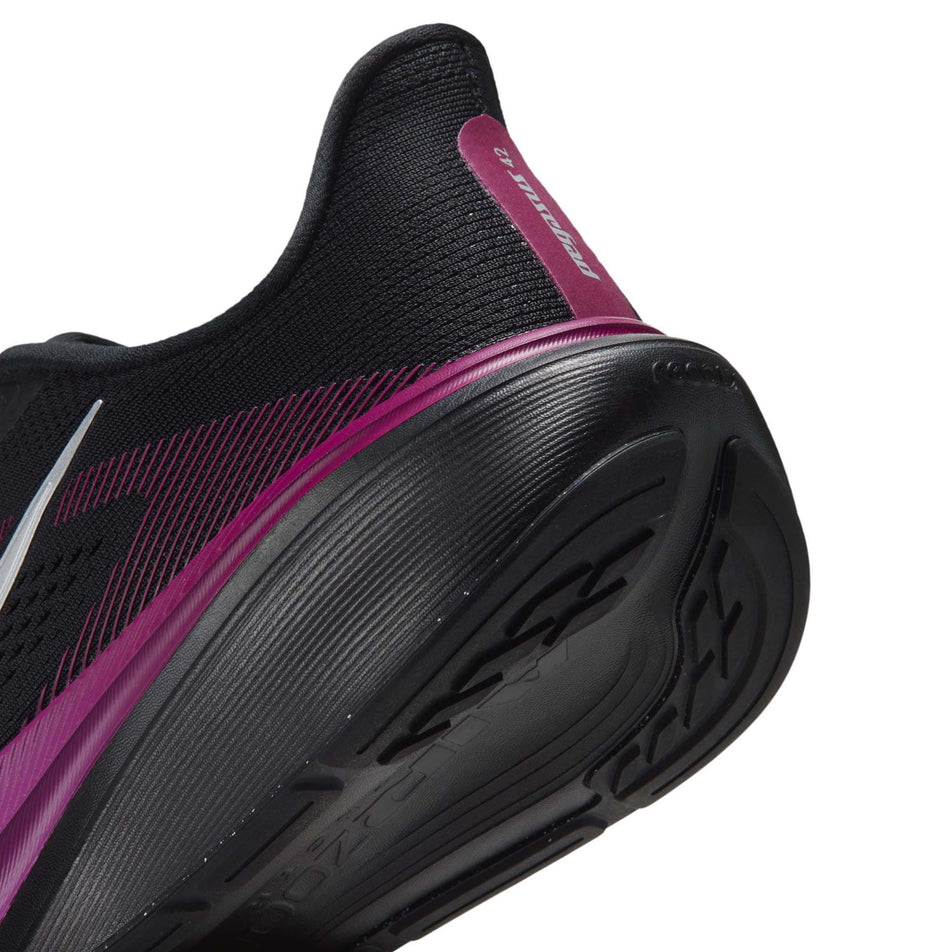 Close-up view of the rearfoot section of the left shoe from a pair of Nike Women's Pegasus 42 Road Running Shoes in the Black/Metallic Silver-Vivid Purple colourway.