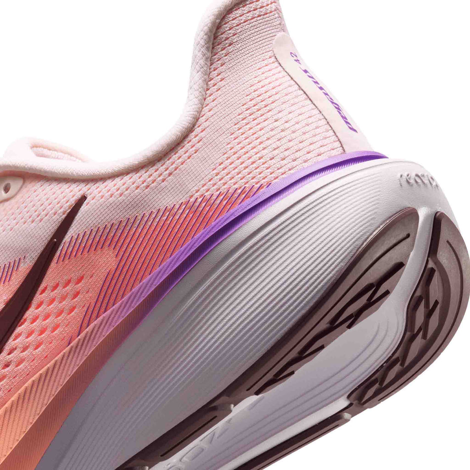 Close-up view of the rearfoot section of the left shoe from a pair of Nike Women's Pegasus 42 Road Running Shoes in the Chalk/Tattoo-Orange Pulse-Bright Violet colourway.