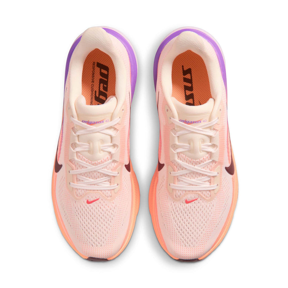 The uppers of a pair of Nike Women's Pegasus 42 Road Running Shoes in the Chalk/Tattoo-Orange Pulse-Bright Violet colourway.