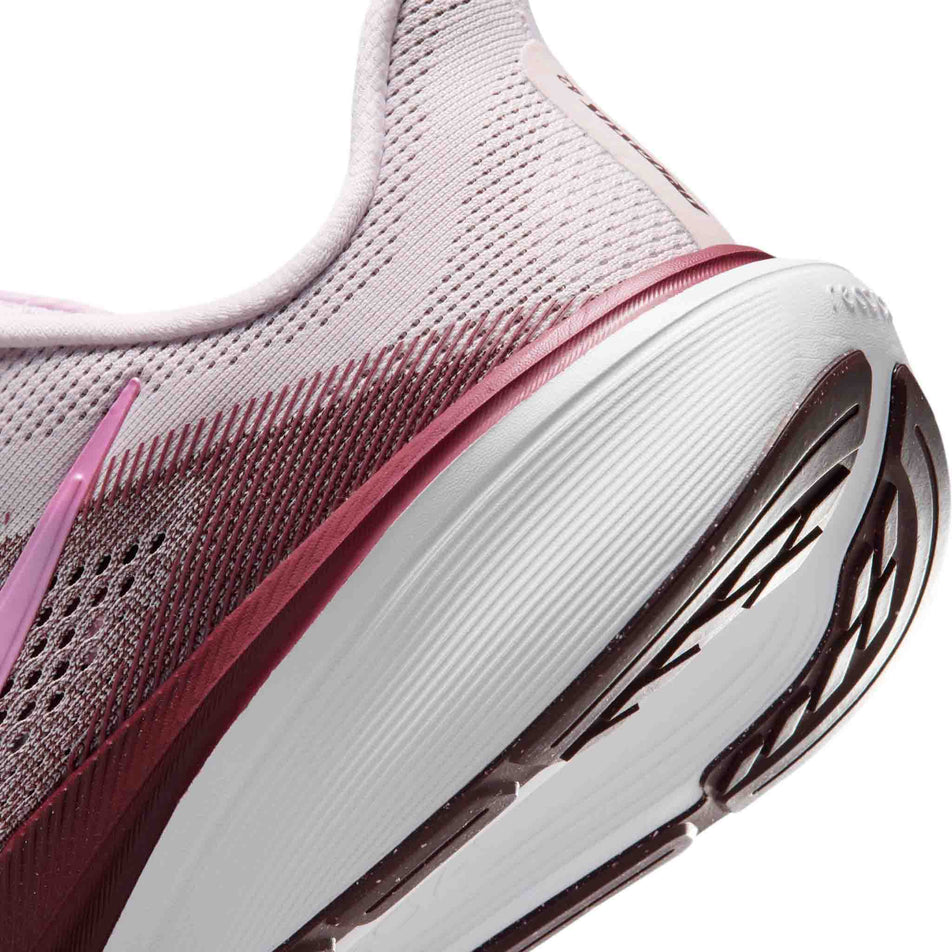 Close-up view of the rearfoot section of the left shoe from a pair of Nike Women's Pegasus 42 Road Running Shoes in the Bleached Lilac/Pink Rise-Mystic Dates colourway.