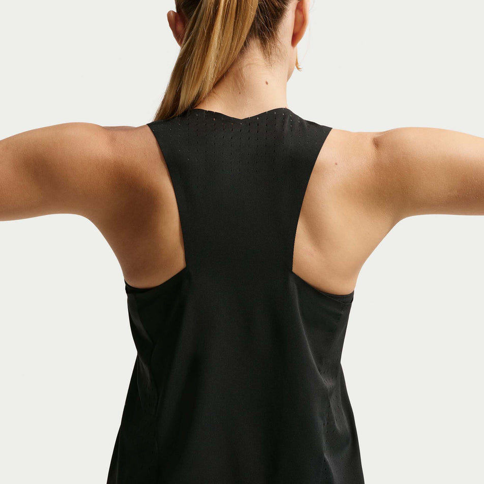 Back view of a model wearing the Nike Women's AeroSwift Dri-FIT ADV Running Singlet in the Black/White colourway.