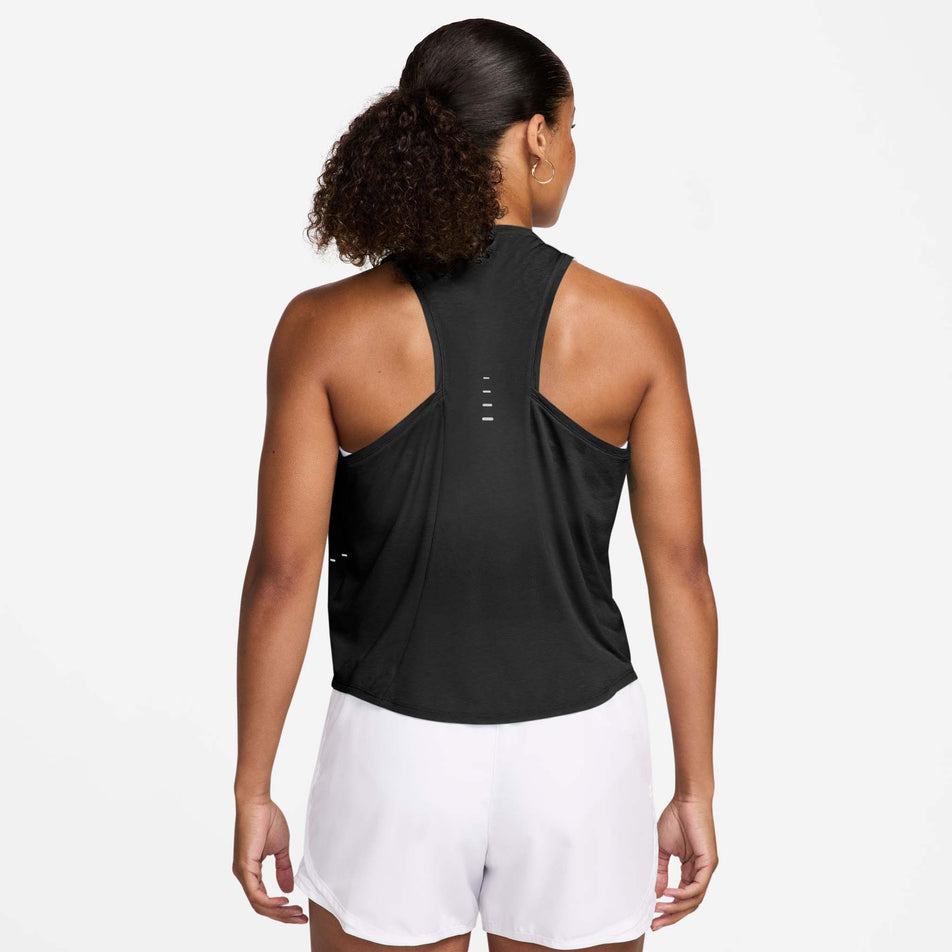 Back view of a model wearing the Nike Women's Swift Breathe Dri-FIT Running Tank Top in the Black/Black/White/Reflective Silver colourway.