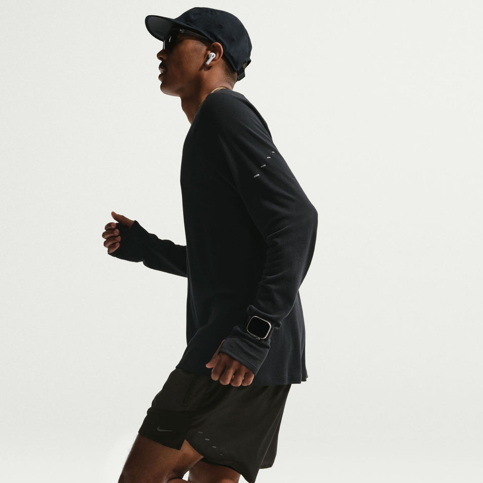 Side view of a model wearing the Nike Men's Stride Plus Dri-FIT 5