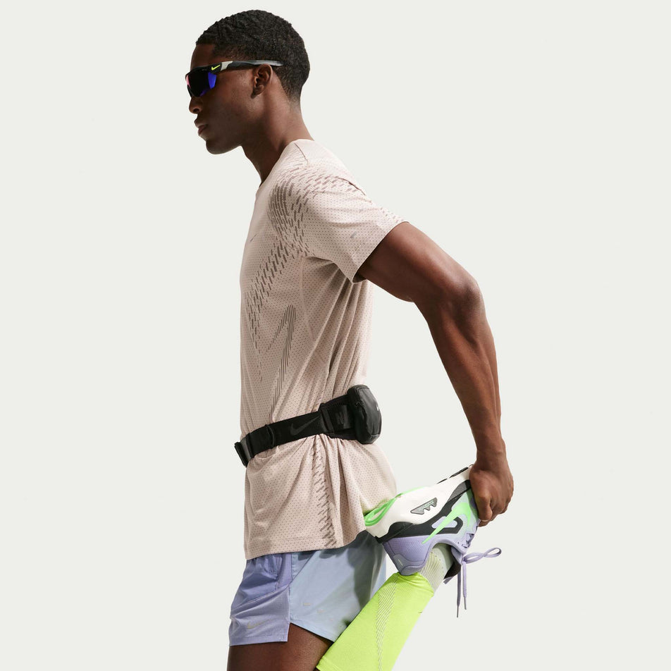Side view of a model wearing the Nike Men's Stride Dri-FIT 5