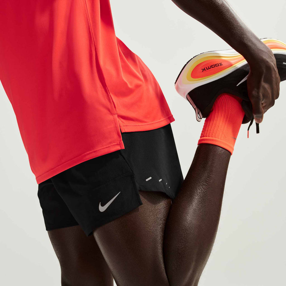 Side view of a model wearing the Nike Men's Stride Dri-FIT 5