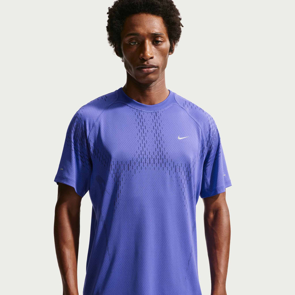 Front view of a model wearing the Nike Men's Stride Plus Dri-FIT ADV Short-Sleeve Running Top in the Lapis/Deep Royal Blue/Reflective Silver colourway.