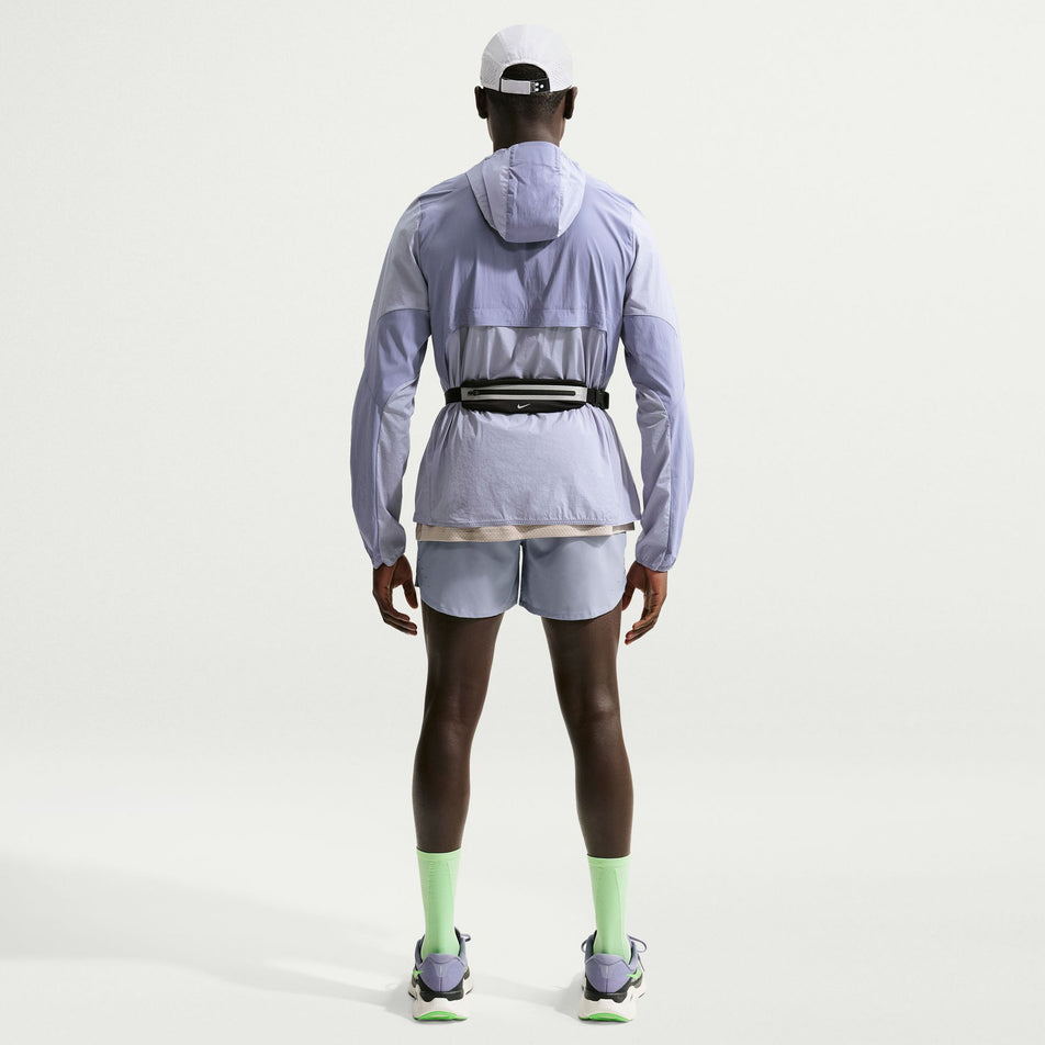 Back view of a model wearing the Nike Men's Stride Repel Running Jacket in the Iron Purple/Indigo Haze/Reflective Silver colourway.