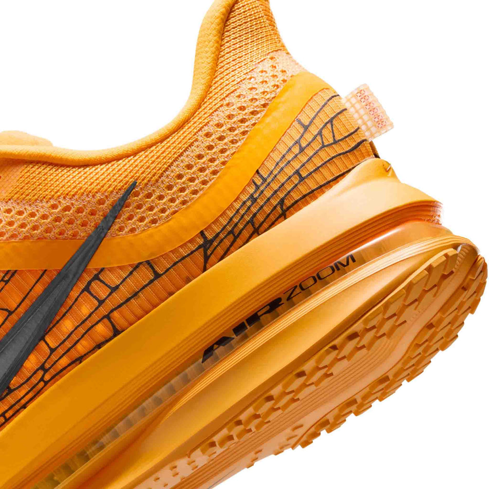 Close up of the midsole of the left shoe from a pair of Nike Men's Pegasus Premium Road Running Shoes in the University Gold/Black-Laser Orange colourway. (8683467800738)