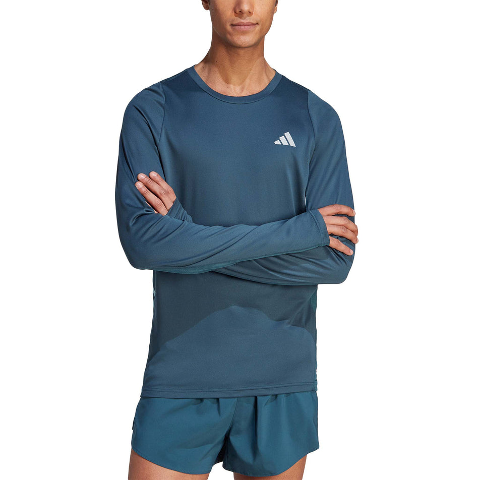 Front view of a model wearing an adidas Men's Run Icons 3-Stripes Long Sleeve Top in the Arctic Night colourway (8005293670562)