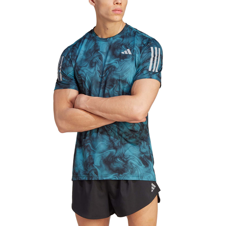 Front view of a model wearing an adidas Men's Own the Run Allover Print T-Shirt in the Arctic Fusion/Black colourway (8005310611618)